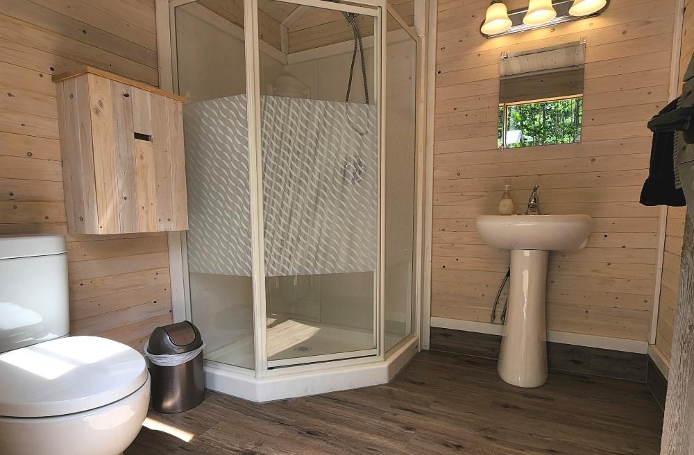 Private bathroom with shower inside Birch Tent glamping accommodation