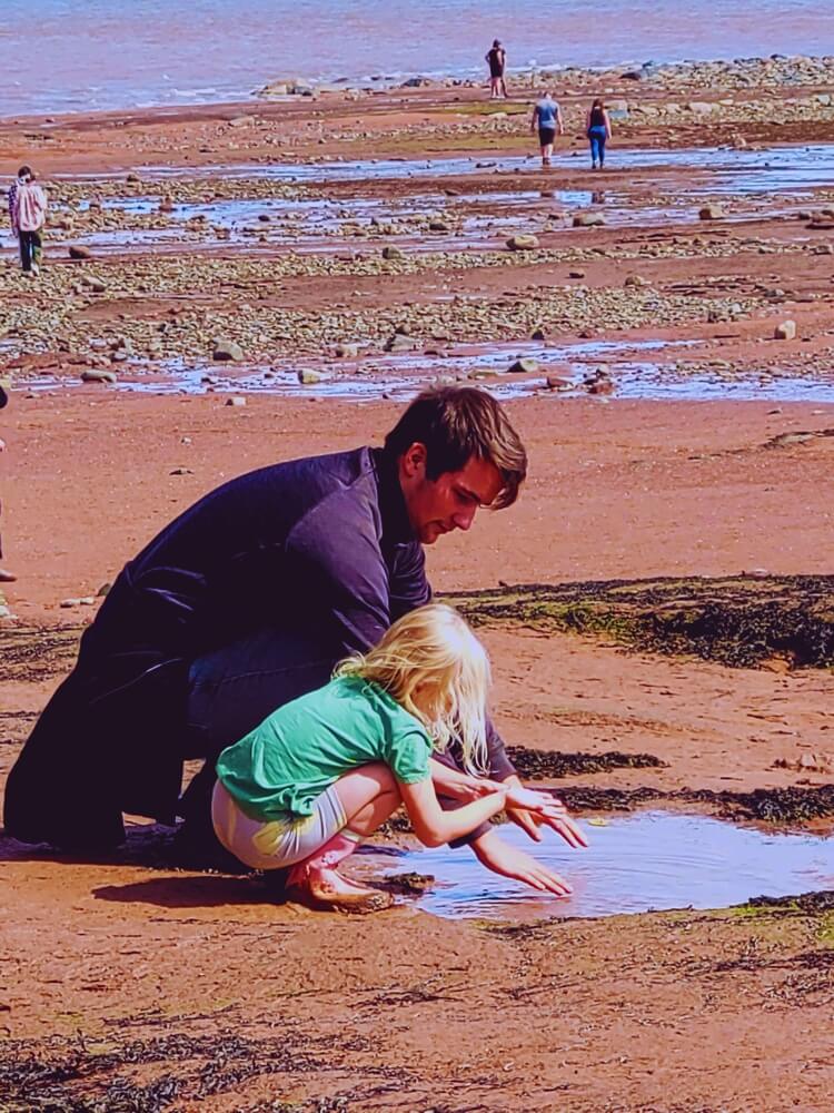 Family exploring tidal flats at Burntcoat Head in the Bay of Fundy