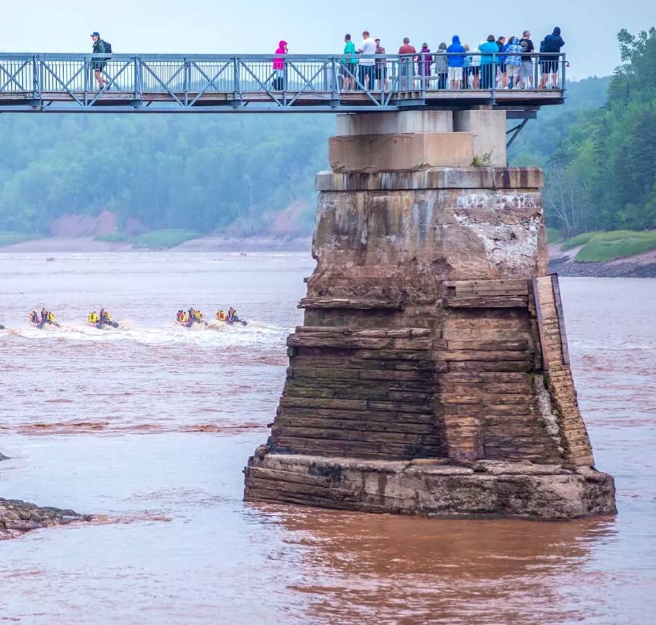 Visitors watching the Fundy tidal bore from a viewing platform in Nova Scotia
