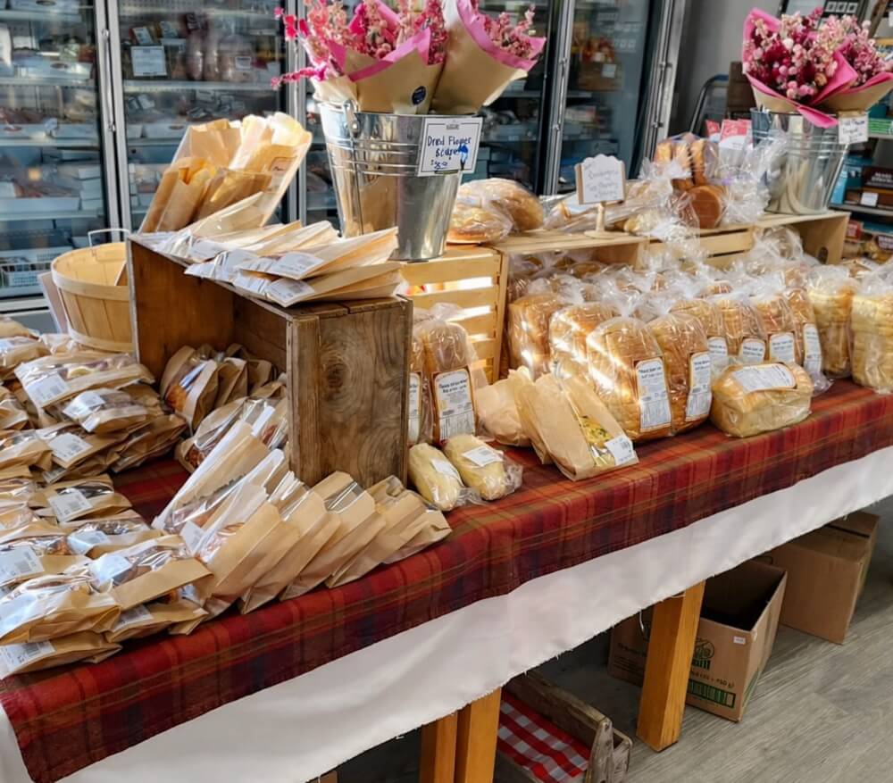 Display of fresh baked goods, local products, and flowers inside Noggins Corner Farm Market in the Annapolis Valley