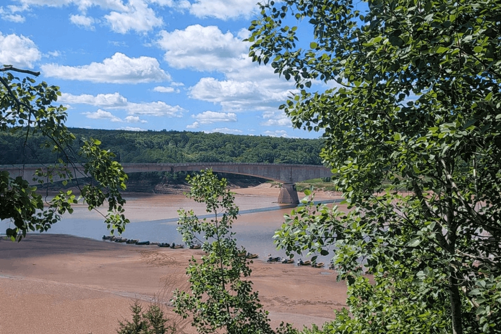 View of the Shubenacadie River and bridge where tidal bore rafting tours launch in Nova Scotia